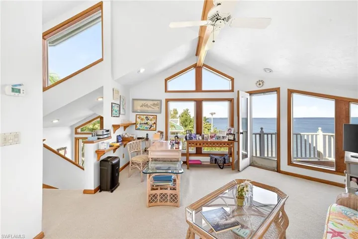Loft/Den room with carpet, high vaulted ceiling, beamed ceiling, and ceiling fan