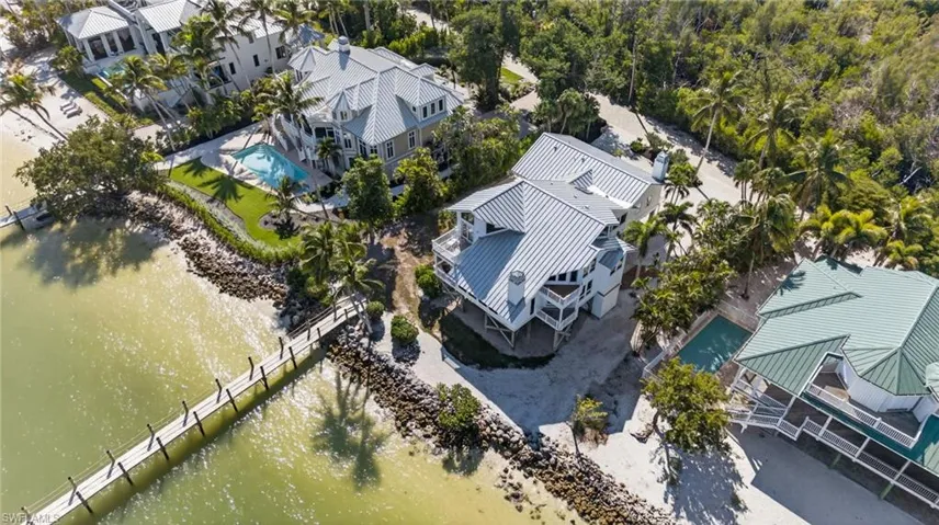Aerial perspective of suburban area featuring a large body of water