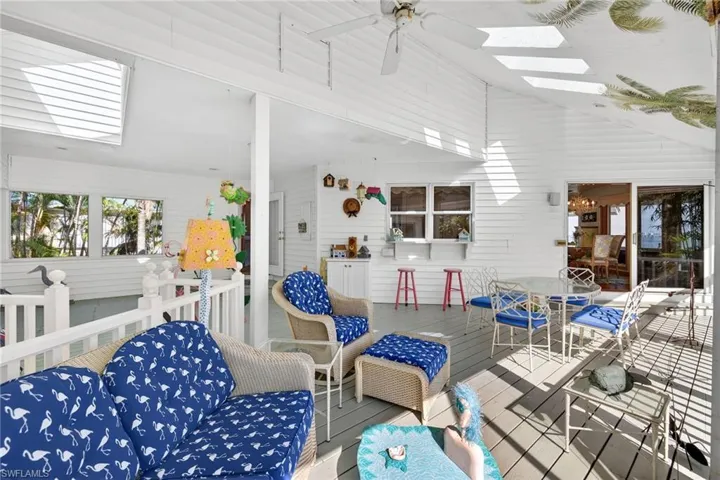 View of patio featuring a ceiling fan, a deck, and outdoor dining area