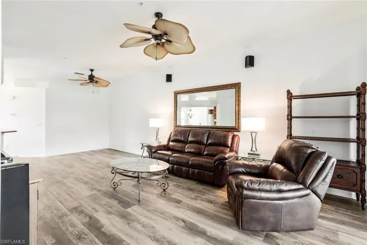 Freshly painted great room with luxury vinyl floors and custom ceiling fans