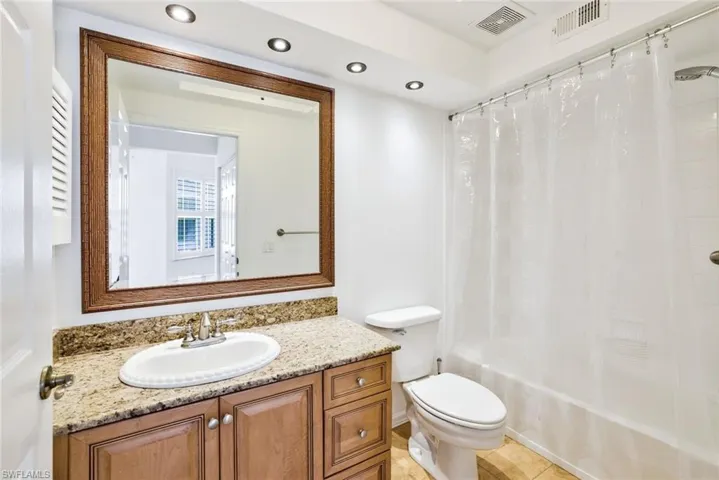 Beautifully appointed 2nd bathroom with granite tops, custom lights and shower/tub combo