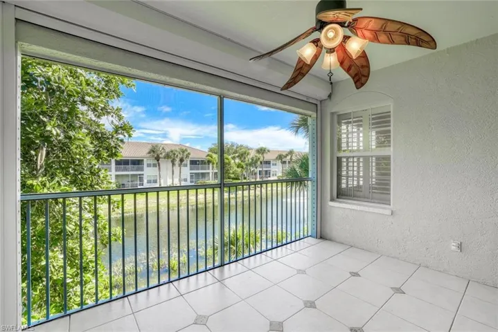 Unfurnished sunroom with ceiling fan