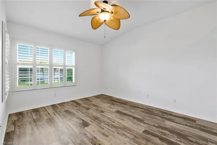 Freshly painted master bedroom with luxury vinyl flooring, plantation shutters and custom ceiling fan