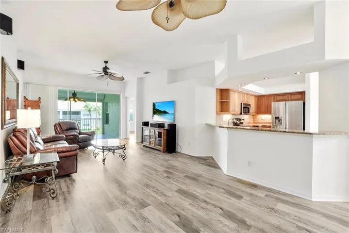 27 ft x 13 ft great room with luxury vinyl flooring, 2 custom ceiling fans