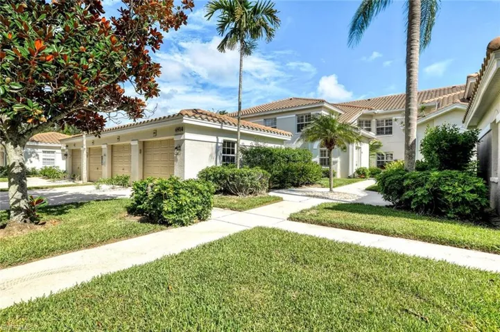 Mediterranean style exterior with detached one-car garage and extra parking