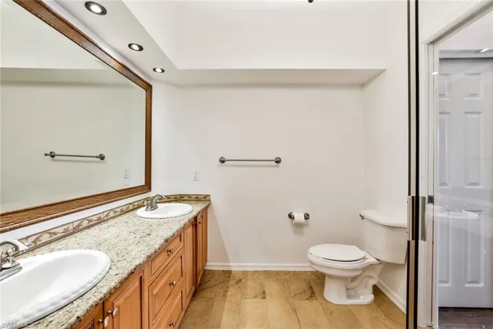 Master bath with dual sinks, granite tops and custom lighting