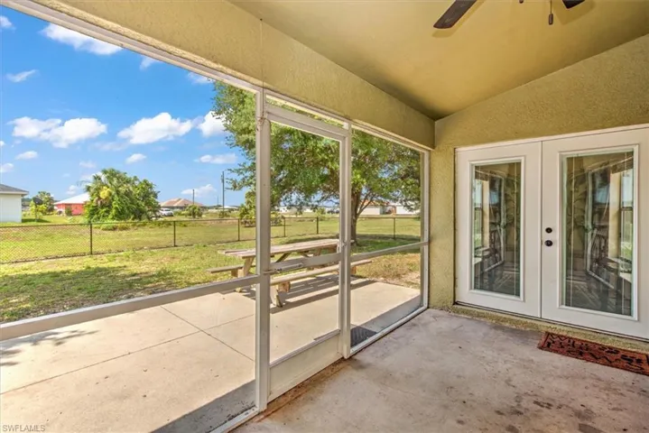 Screened lanai and open patio with fenced yard.