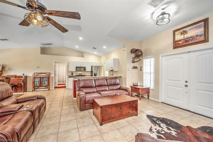 Living room with upgraded fixtures, tile floors, and open concept.