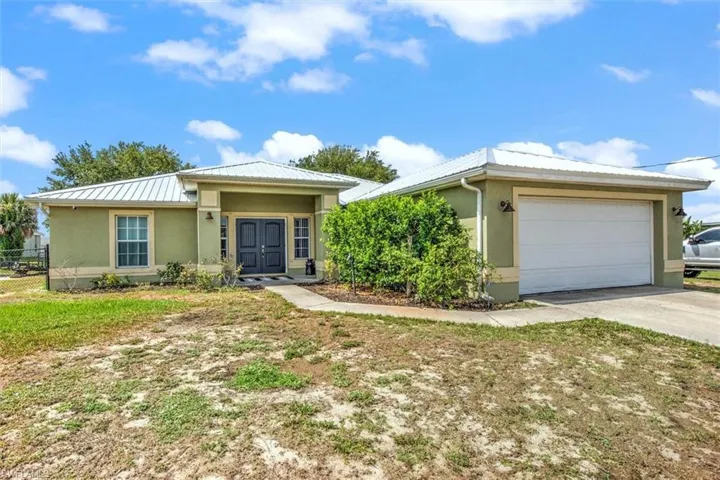 Two car garage featuring a fenced back yard.