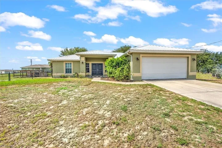 Ranch-style home on half acre lot with recently installed Galvalume roof.