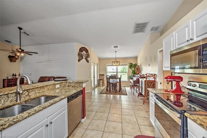 Kitchen featuring granite tops, stainless appliance package and pantry