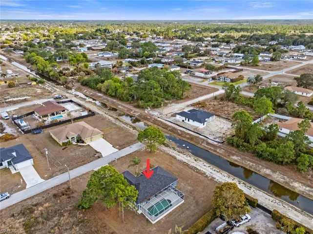 Aerial view of property's location with nearby suburban area and a large body of water