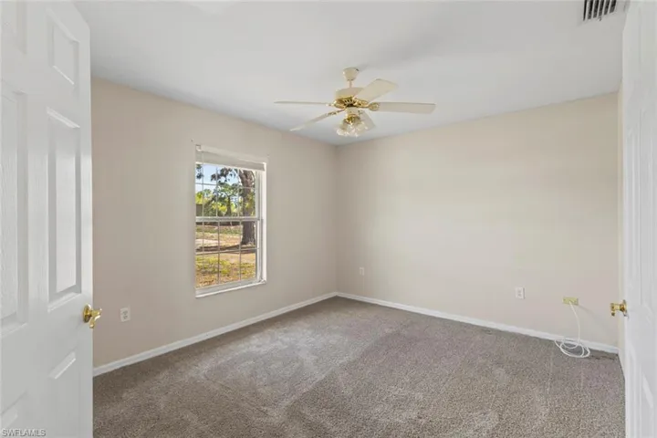 Guest room #1 featuring carpet floors and ceiling fan