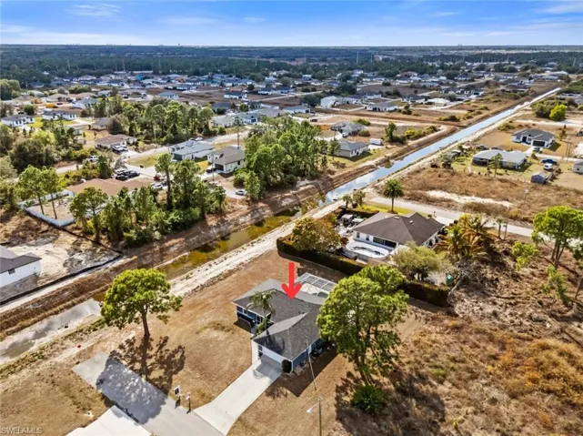 Aerial overview of property's location with nearby suburban area and a nearby body of water