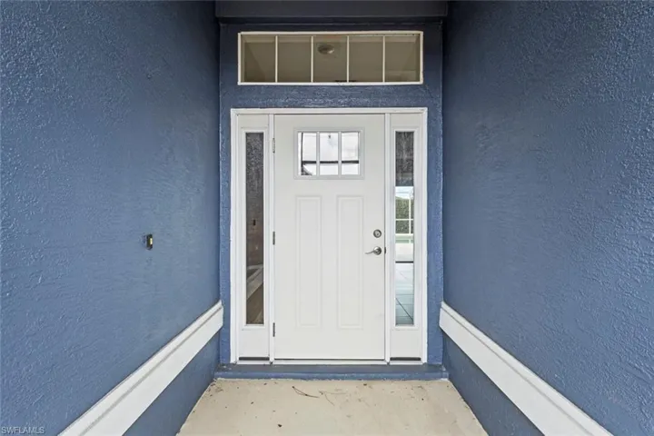 Entrance to property with stucco siding