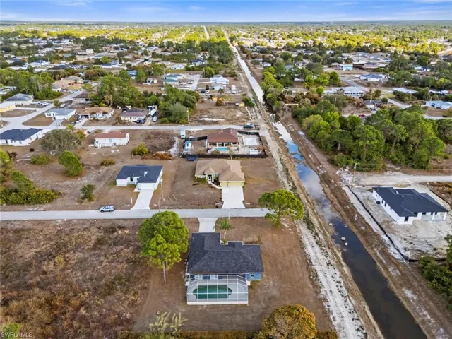 Aerial overview of property's location featuring nearby suburban area