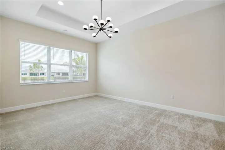 Master bedroom features designer light fixture