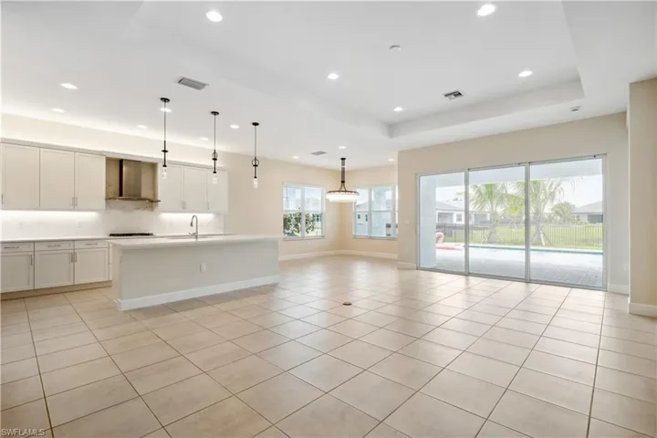 Expansive view of kitchen, living room, and dining.  Upgraded designer light fixtures
