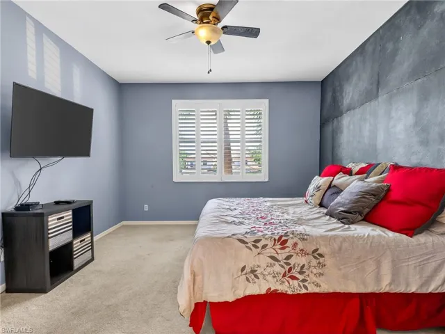 Bedroom featuring carpet floors and ceiling fan