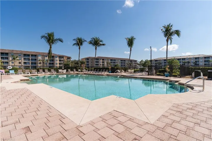 Pool featuring fence and a patio