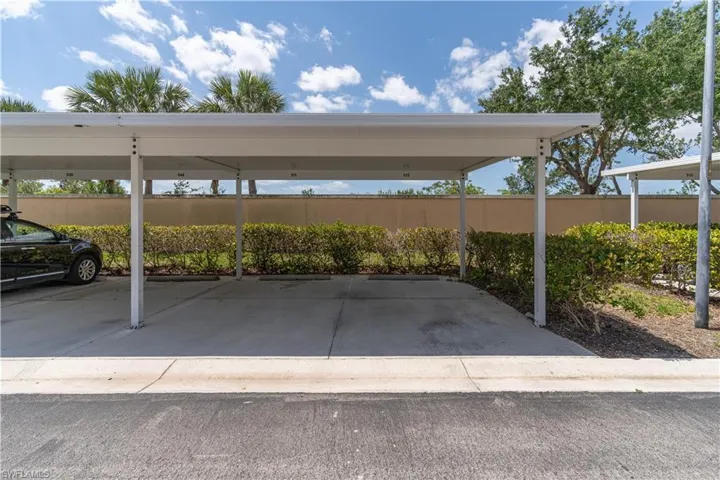 Covered parking lot featuring fence