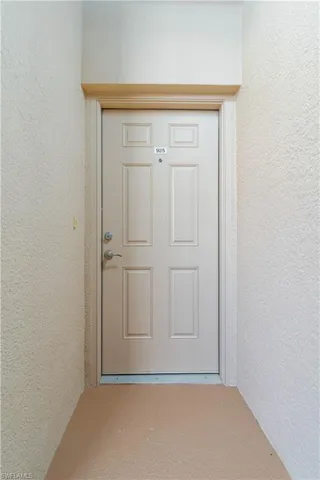 Doorway to property featuring stucco siding