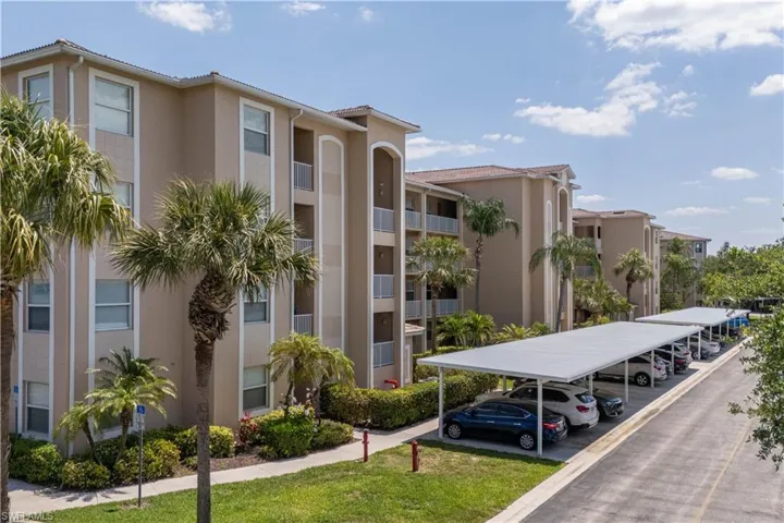 View of property featuring covered parking