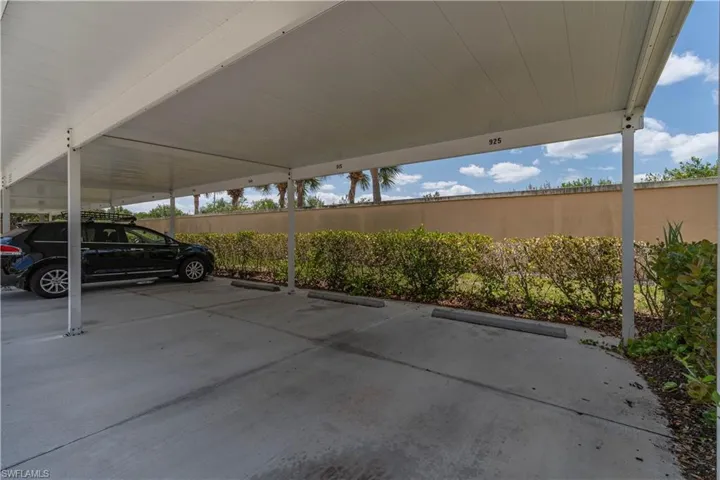 Covered parking lot featuring fence