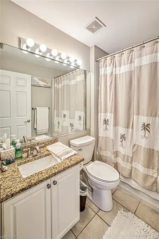 Bathroom with tile floors, vanity, and toilet