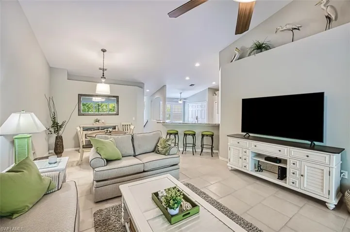 Living room featuring ceiling fan and light tile floors