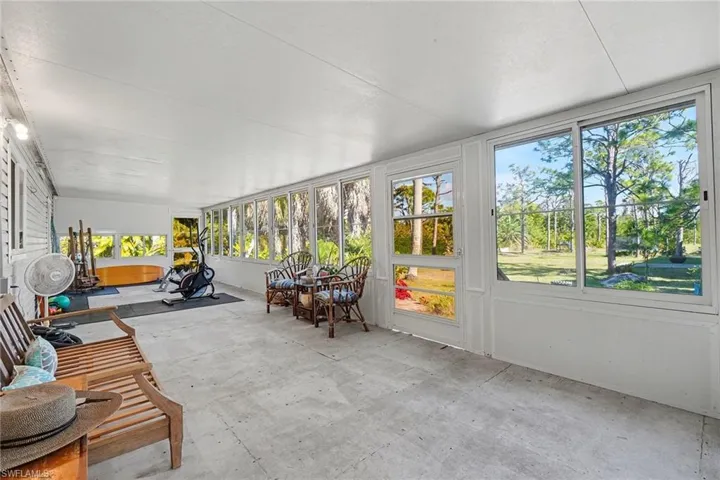 Large sunroom / solarium used for entertaining and working out that is the length of the home.  Overlooks the beautiful property and is a multipurpose space.