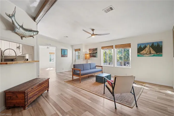 Living area with light wood-type flooring and ceiling fan