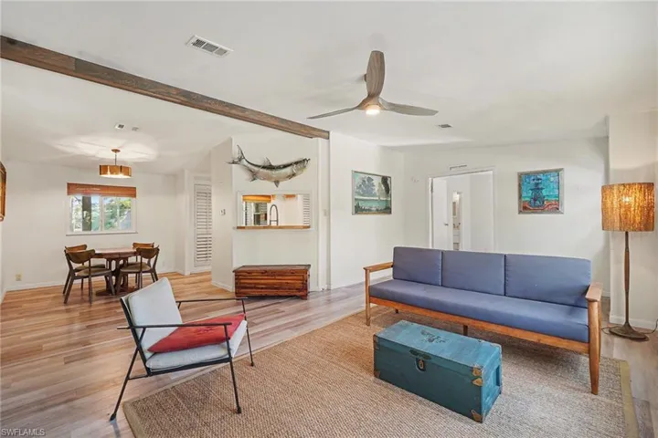 Living area with a ceiling fan and light wood-type flooring