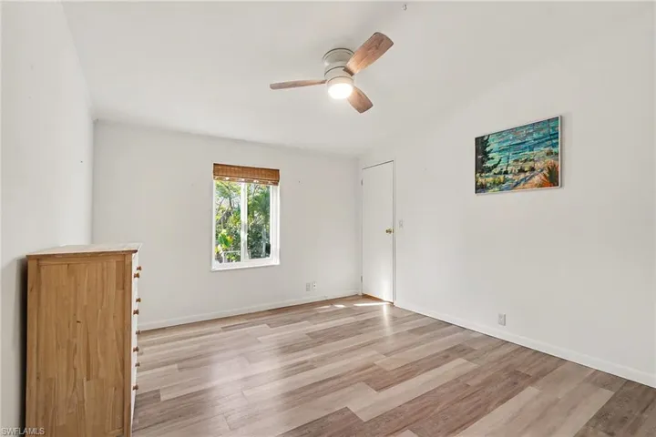Front bedroom featuring light wood-type flooring and ceiling fan