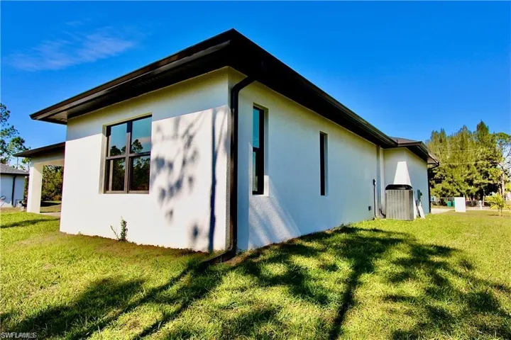 View of side of home featuring a yard