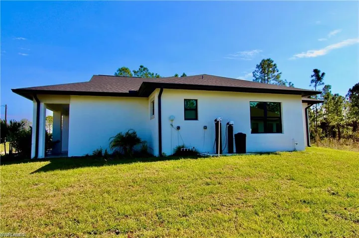 Back of house featuring a lawn