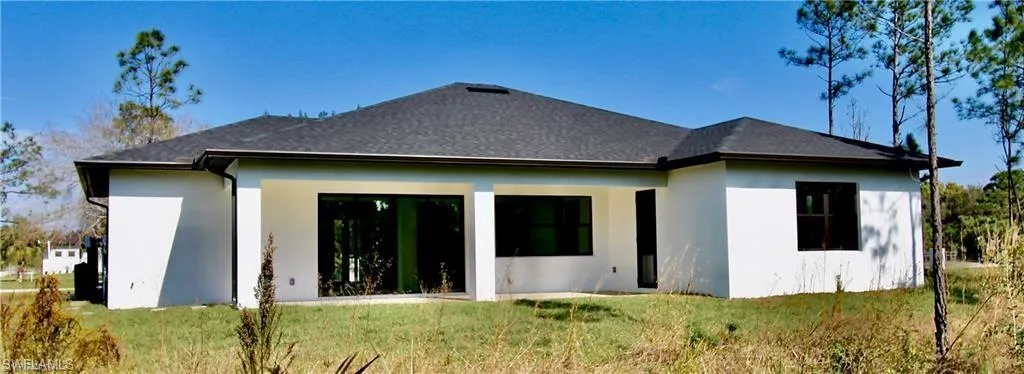 Rear view of house with a lawn