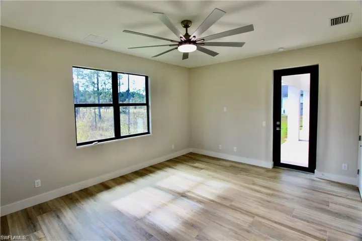 Spare room featuring ceiling fan and light wood-type flooring