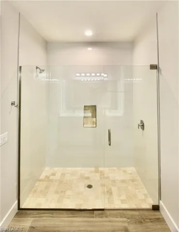 Bathroom with hardwood / wood-style floors and walk in shower