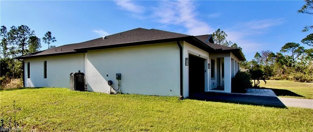 View of side of property with a lawn