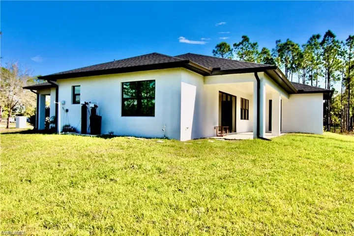 Back of property featuring a patio area and a yard