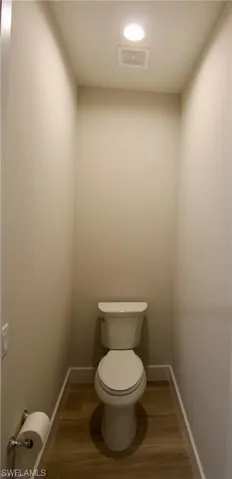Bathroom featuring toilet and hardwood / wood-style flooring