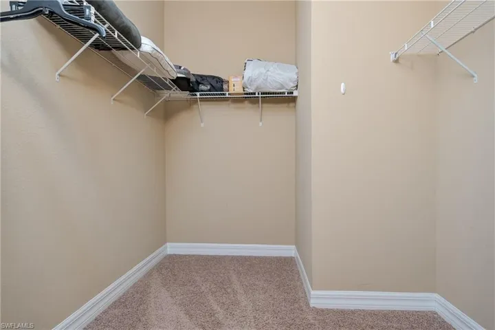 Walk in closet featuring carpet