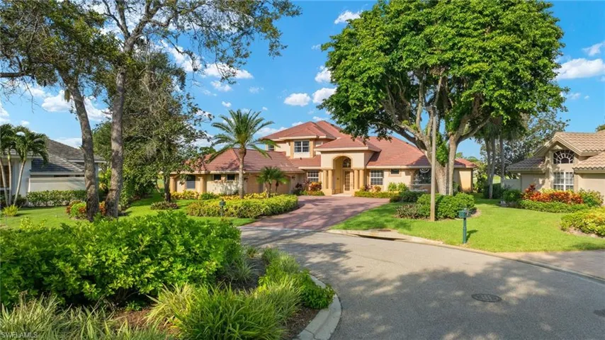 Mediterranean / spanish-style house with a front yard