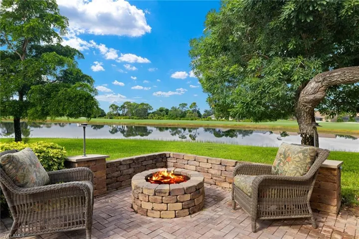 View of patio featuring a water view and a fire pit