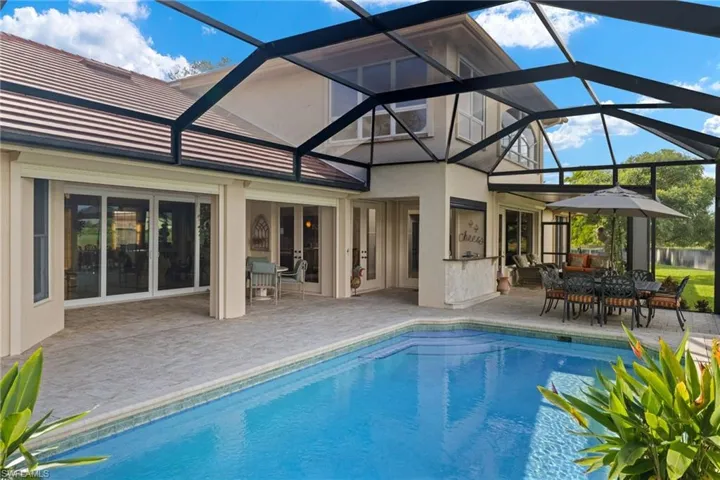 View of swimming pool with a lanai and a patio