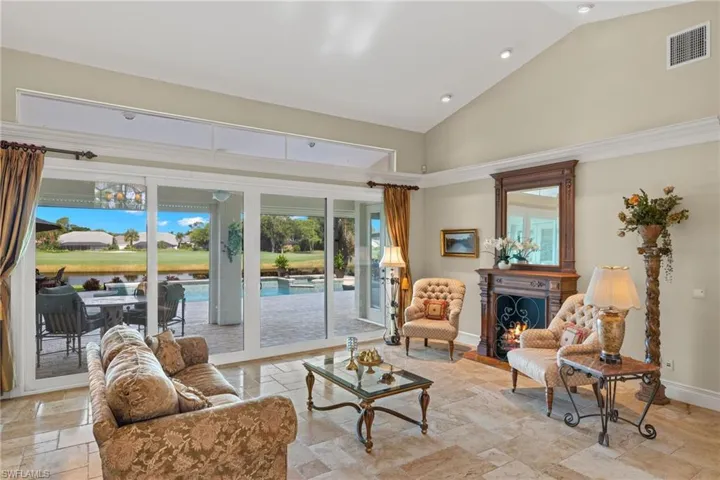 Living room featuring high vaulted ceiling