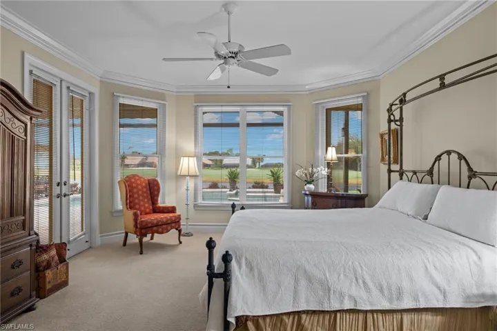 Carpeted bedroom featuring crown molding, ceiling fan, and access to exterior