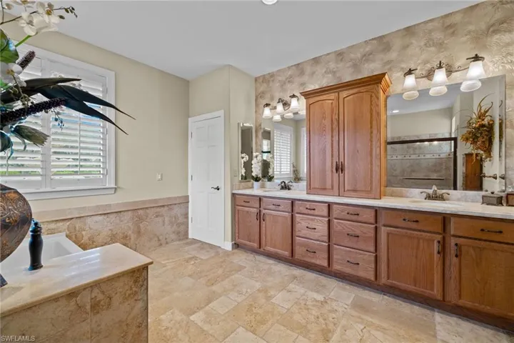 Bathroom featuring vanity and shower with separate bathtub
