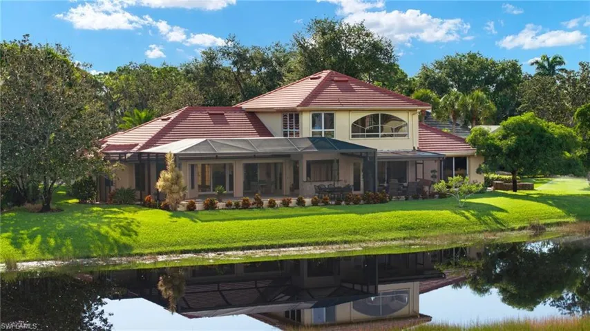 Back of property featuring a yard